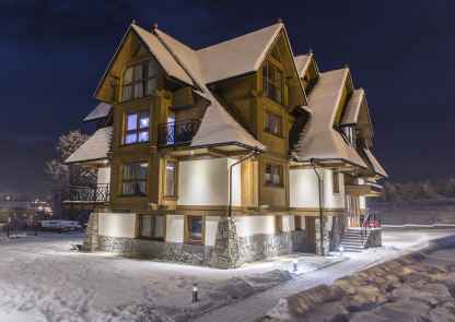 Polana Szymoszkowa Ski Resort - budynek w stylu góralskim z elementami kamienia, drewna
